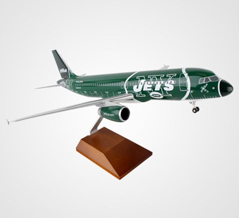 Photo of model airplane wrapped in Jets team branding mounted on a wood pedestal